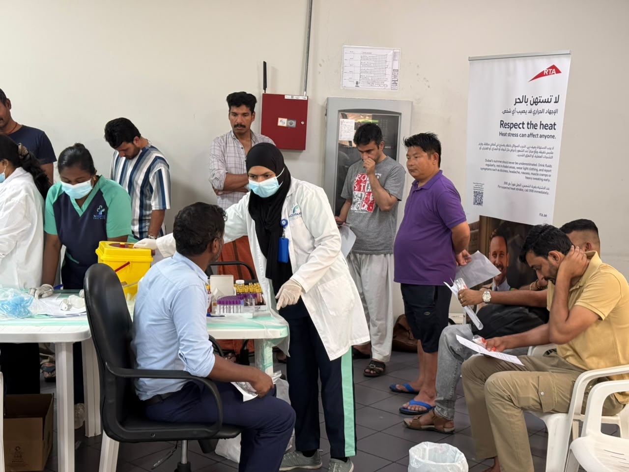 Moopans medical camp team assisting attendees at a health screening station